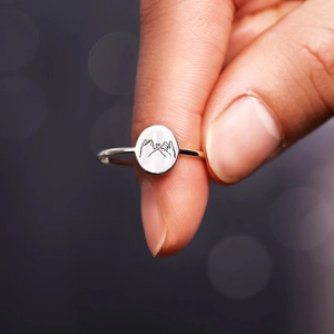 Macro detail of S925 sterling silver pinky swear promise ring with oval seal design