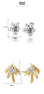 Detail display of vintage pearl stud earrings in silver cluster and gold radial designs