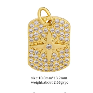 Macro shot of rectangular gold starburst pendant with dimensions 18.8mm by 13.2mm