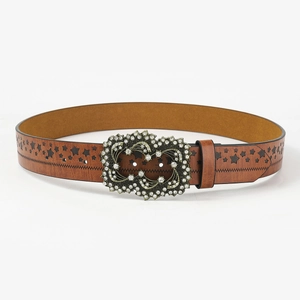 Detail of a brown leather belt featuring hollow star patterns and a large rhinestone buckle