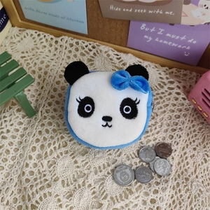 Detailed view of plush panda coin purse with blue bow and fine embroidery details