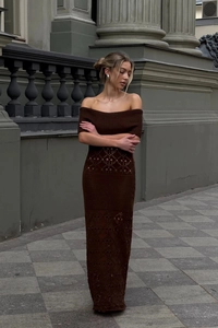 Detail of hollow-out geometric knit pattern on a dark brown off-shoulder maxi dress
