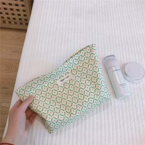 Detailed close-up of floral cotton makeup bag featuring simple wish tag and soft zipper