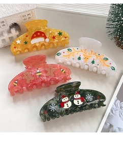 Nahaufnahme von bunten Weihnachts-Haarklammern mit Lebkuchen und Rentier-Motiven