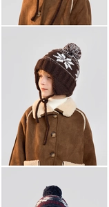 Detail of snowflake jacquard knit hat with earflaps and plush faux fur pom-pom