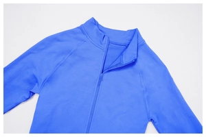 Detail of bright blue yoga jacket featuring a stand collar and high-stretch ribbed fabric