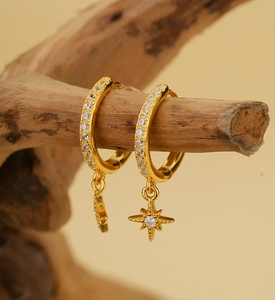 Detailed view of gold S925 sterling silver star drop earrings with sparkling pavé cubic zirconia