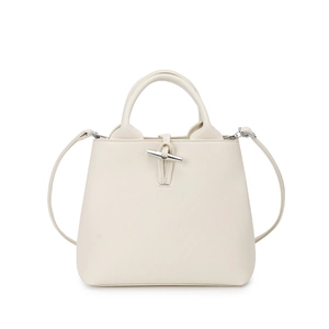 Off-white lychee grain leather bucket bag with silver toggle closure and crossbody strap