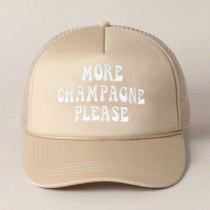 Detail of embroidered 'MORE CHAMPAGNE PLEASE' text on beige trucker hat with mesh and rope