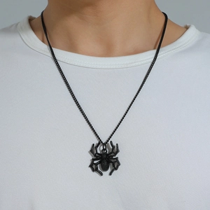 Gothic black spider pendant necklace worn by a model on a clean white background