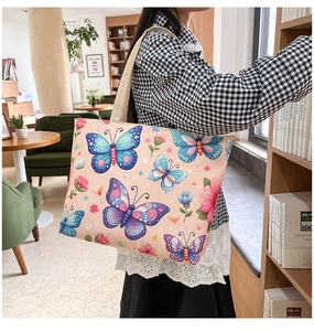 Close-up of ethnic style canvas tote bag featuring vibrant butterfly and floral prints