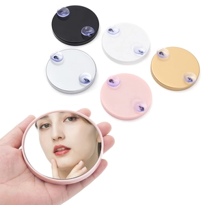 Macro view of portable round magnifying mirror showing 5 color variants and suction cups
