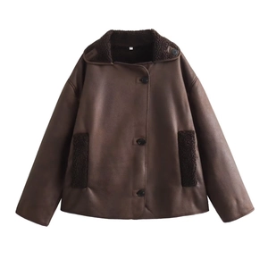Detail shot of a dark brown faux shearling jacket featuring lapels and suede texture