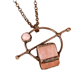 Vintage bronze necklace with square rose quartz pendant on a minimalist white background