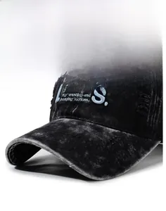 Detailed view of vintage washed black denim baseball cap with distressed embroidery and rips