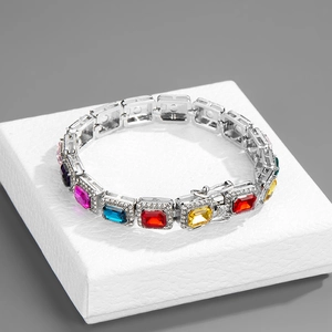Detail of silver Cuban chain featuring colorful rectangular gemstones and pave crystals