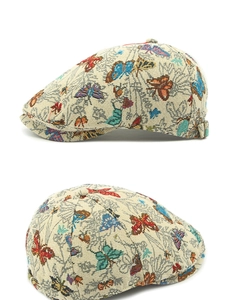 Detail of colorful butterfly jacquard pattern on retro off-white flat cap for women