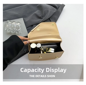 Capacity display of gold envelope bag showing space for phone and cosmetics