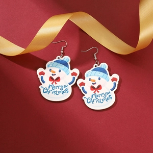 Detail view of snowman acrylic hook earrings with Merry Christmas lettering on red background