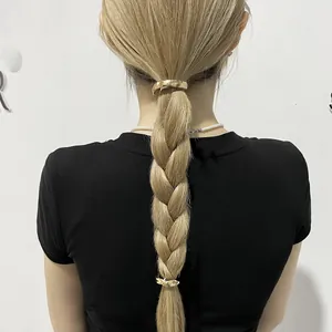 Minimalist golden metal hair clip accessory shown on a braided ponytail style