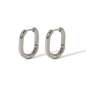 Close-up of polished oval stainless steel hoop earrings with minimalist high-shine finish