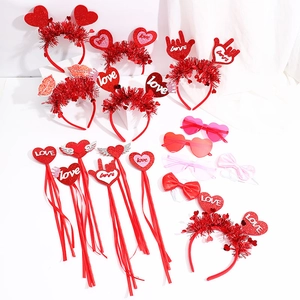Close-up of Valentine's Day party favors including heart headbands and LOVE wands