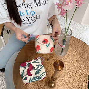 Mini floral fabric pouch with vintage button closure and purple loop ring for accessories