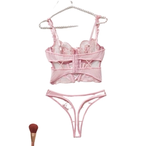 Charming pink floral lace lingerie set with ruffled straps and mesh thong on hanger