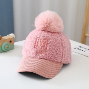 Close-up of pink teddy fleece baseball cap with M BABY embroidery and corduroy brim