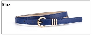 Detail view of navy blue skinny belt with a golden round buckle and decorative metal rings