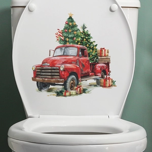 Christmas red truck and tree sticker on a white toilet lid for festive bathroom decor