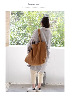 Detailed shot of large capacity canvas tote bag in brown with wide shoulder strap