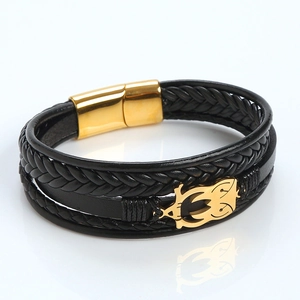 Detail of multi-layer black leather bracelet with owl charm and gold magnetic clasp