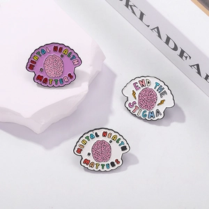 Three enamel pins featuring colorful brain patterns with Mental Health Matters slogans