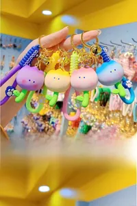 Detail of four resin tulip keychains in purple yellow pink and blue with Good Cool straps