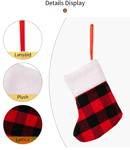 Detail display of red plaid Christmas stocking with plush cuff and silk hanging loop