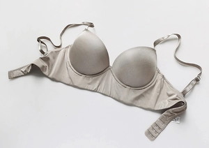 Detailed flat lay of champagne silk push-up bra with smooth texture and seamless design