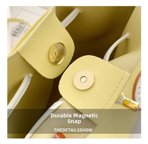 Detail of yellow bucket bag with strong gold magnetic buckle and white drawstring