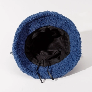 Detail showing internal black lining and adjustable drawstring of navy lamb wool bucket hat