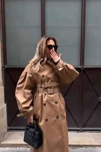Detail of classic khaki double-breasted trench coat with unique double belt design
