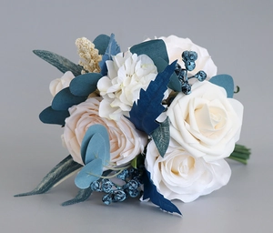 Close-up of Morandi-style wedding bouquet with white roses and eucalyptus leaves