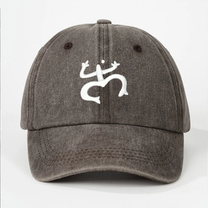 Detailed view of Coqui frog embroidery on washed cotton baseball cap with white background
