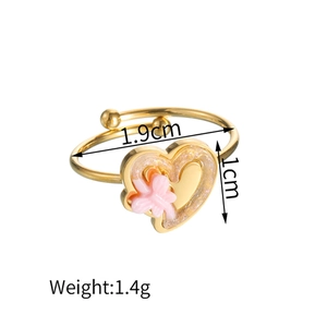 Detailed view of golden heart ring featuring a pink butterfly with weight and size specs