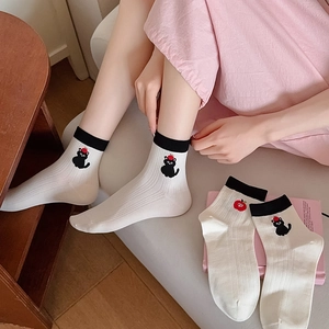 Cream cotton socks with cute black cat and apple embroidery, featuring ribbed black cuffs