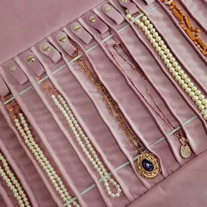 Pink velvet jewelry organizer roll with metal snaps for necklaces and pendants