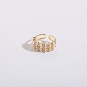 Detail of 14K gold plated ring featuring three rows of pearls and zircon stones