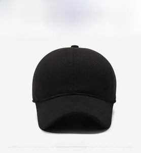 Front view of black wool baseball cap for men featuring a side metal logo and curved brim