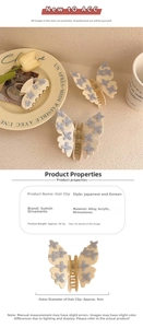 Détail d'une pince papillon crème avec accents bleus, taille 9cm et poids de 36,7g