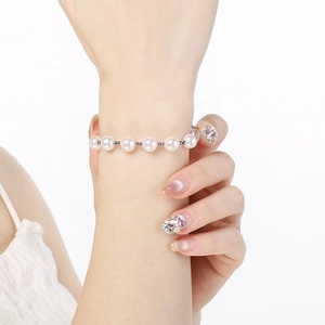 Detailed view of elegant pearl bracelet with silver spacers on female wrist