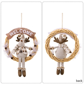 Front and back detail of a Christmas wreath with a plush reindeer and Welcome banner